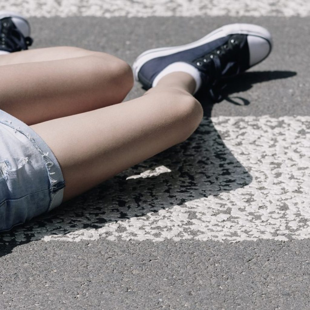 High angle on a child on a crosswalk hit by a car High angle on a child on a crosswalk hit by a car